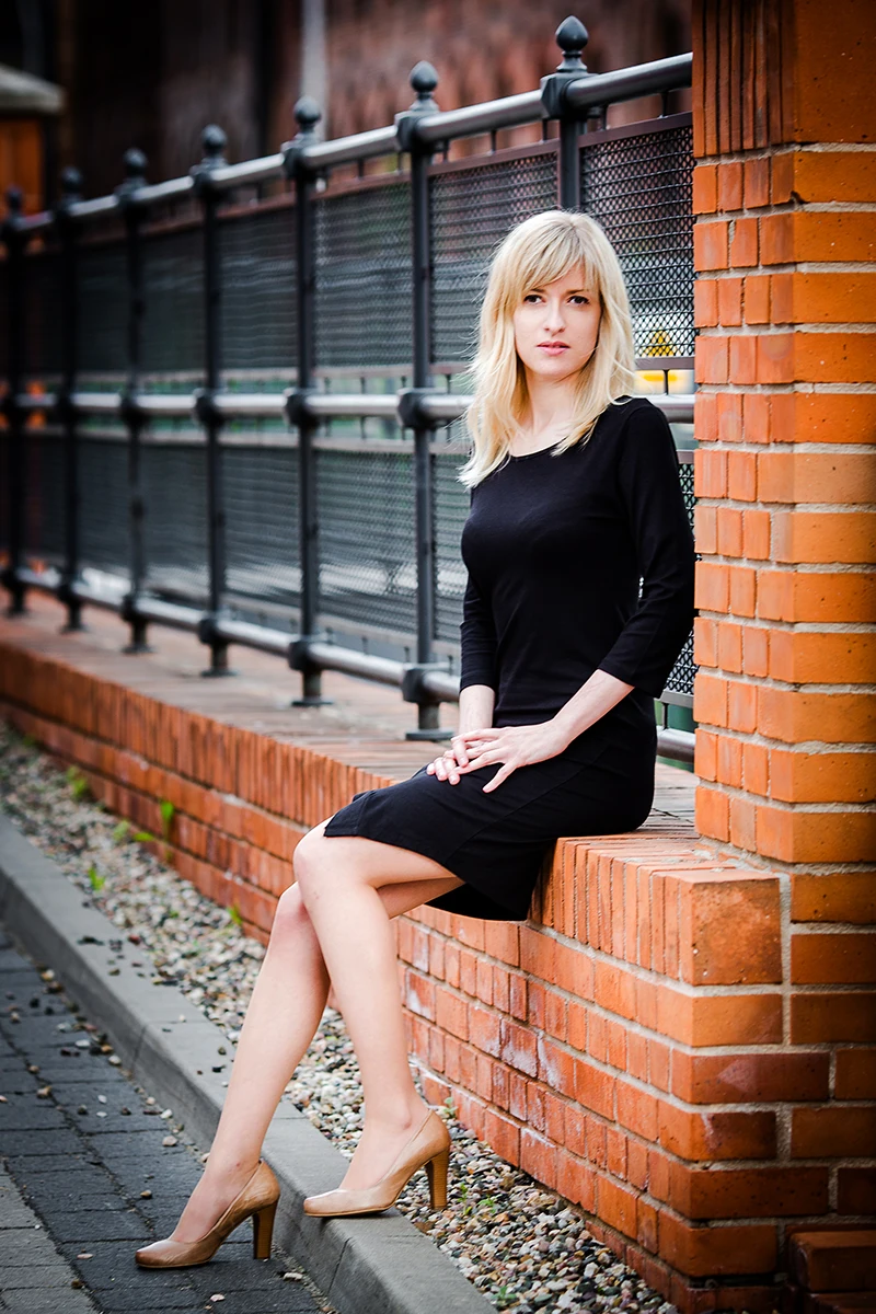 Elegancka poza, modelka w loftach, czarna sukienka, Sesja Modowa Księży Młyn.